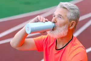 Homem de Meia Idade Se hidratando durante o treino